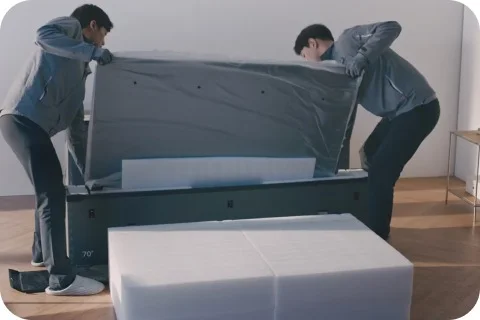 LG가전 케어 전문가가 TV를 덮개로 감싸 케어하는 모습