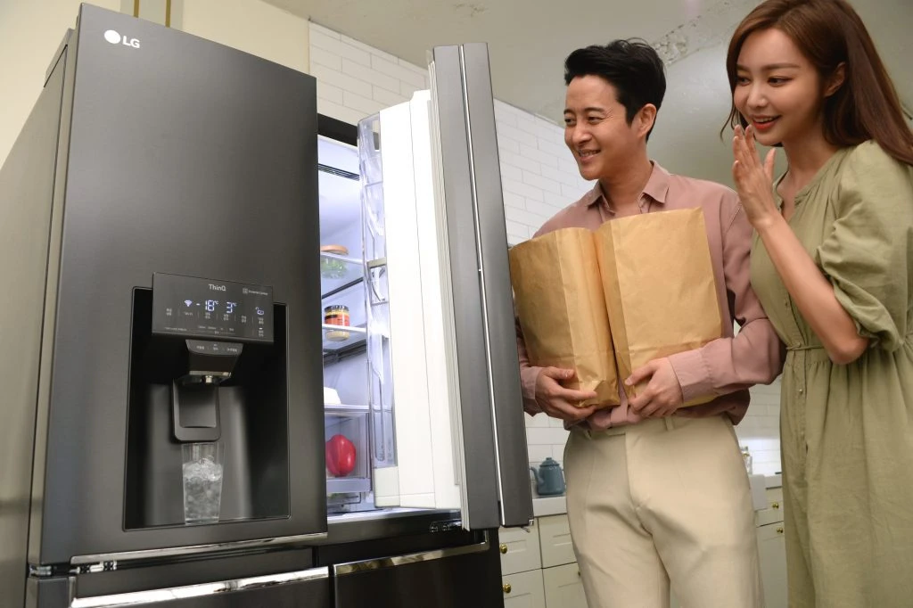모델들이 음성으로 문이 열리는 냉장고를 소개하고 있다.
