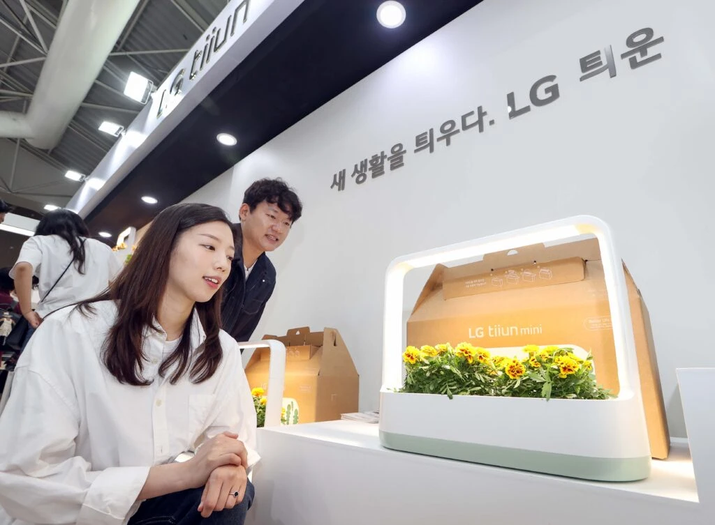 LG전자가 27일부터 내달 8일까지 경기도 고양시 일산호수공원에서 열리는 2023 고양국제꽃박람회에서 식물생활가전 LG 틔운과 틔운 미니를 통해 ‘반려(伴侶)식물 라이프’를 알린다. 모델이 LG 틔운 미니에서 자라고 있는 꽃을 감상하고 있다.